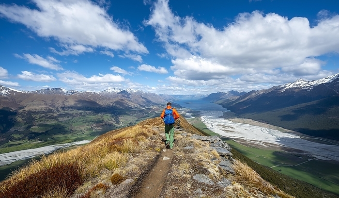 Hiker on the summit of Mount Alfred, views of Lake Wakatipu and mountain scenery, Glenorchy near Queenstown, Southern Alps, Otago, South Island, New Zealand, Oceania