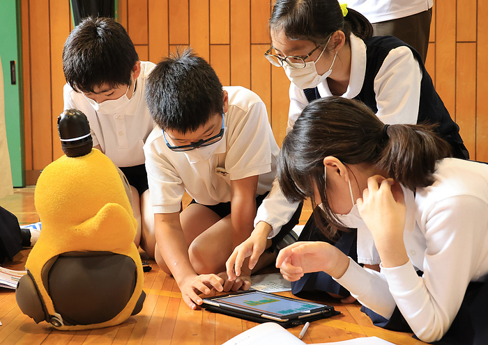 Elementary school children learn the programming to operate a robot for their compulsory lesson October 6, 2020, Tokyo, Japan   Sixth grader children of the Ouji daini elementary school learn the programming to operate a communication robot LOVOT, developed by Groove X using a tablet at their school in Tokyo on Tuesday, October 6, 2020. Japan started computer programming lessons in elementary schools compulsorily from this year to build the foundations of the information technology.        Photo by Yoshio Tsunoda AFLO 