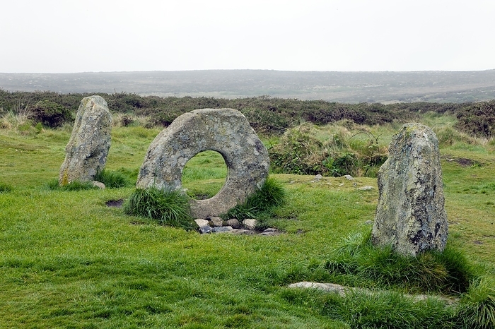 Men an tol standing stones Men an tol standing stones. This formation of standing stones is thought to be the remains of a Neolithic burial chamber, with the circular shaped stone forming the entrance. The stones were later the site of traditional rituals which involved passing children through the hole in the belief that it would cure them of tuberculosis and rickets. Photographed near Madron in Penwith, Cornwall, UK.