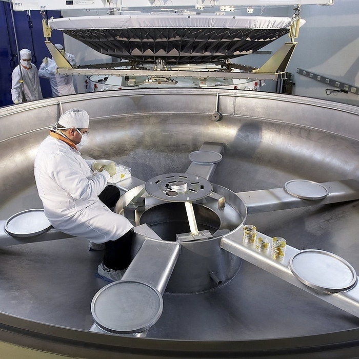 Herschel space telescope construction Herschel space telescope construction. Technicians checking the quality of the aluminium coating used on the M1 mirror  upper centre  of the Herschel space telescope. Sample mirrors  centre  were placed in the metal coating chamber at the same time as the M1 mirror and are used to check the metallic layer for consistency. With its primary mirror measuring 3.5 metres in diameter, the European Space Agency s Herschel telescope is the largest space telescope ever built  larger than the Hubble telescope which has a diameter of 2.4 metres. Photographed at the Calar Alto astronomical observatory, Spain.