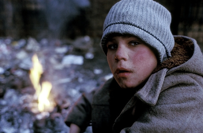 Street child, Romania Street child, in Bucharest, Romania, by a fire. There may be several thousand Romanian street children, some as young as ten. The causes of this social problem include poverty, violence, and alcoholism, caused in part by the chaos that followed the downfall of the Ceausescu regime in 1989. Many of these children have ended up on the street to escape neglect or abuse from their families or orphanage workers. They support themselves by begging, stealing, and prostitution, though some receive support from charities.