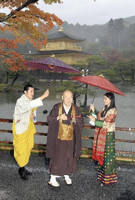  The King and Queen of Bhutan Visits Japan Visit to Kinkakuji Temple King Wangchuck of Bhutan  left  and Queen Jetsun Pema of Bhutan offer umbrellas to Chief Priest Arima  center  at 8:18 a.m. on August 19 at Kinkakuji Temple in Kita Ward, Kyoto City.