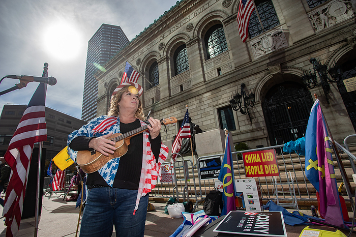 Trump rally in Boston October 18, 2020, Copley Square, Boston, Massachusetts, USA: A Trump supporter plays a guitar during a rally in support of U.S. President Donald Trump sponsored by Super Happy Fun America, in Boston.  Photo by Keiko Hiromi AFLO  