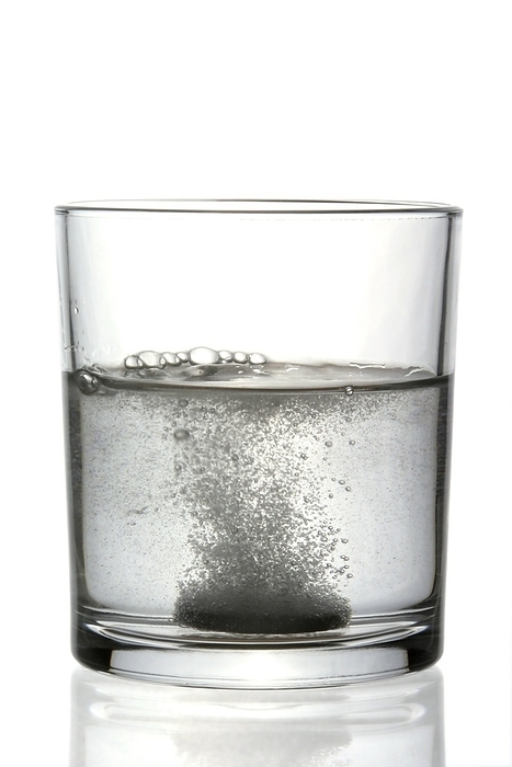 Soluble pill Soluble pill dissolving in a glass of water.