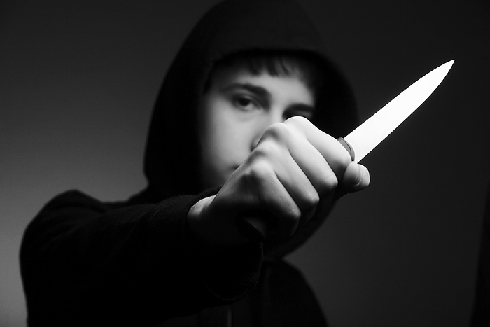 Youth knife crime Youth knife crime. Youth holding a knife in a threatening manner.