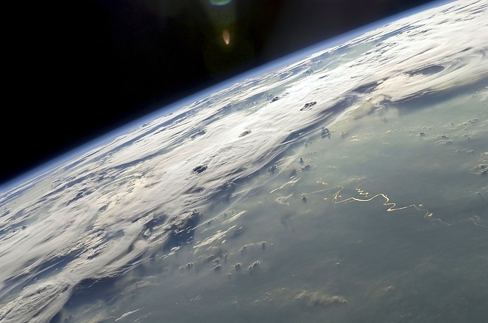 Thunderstorms over Brazil, ISS image Thunderstorms over Brazil, ISS image. Image taken by astronauts aboard the International Space Station  ISS  of the Amazon Basin in Brazil. North is right. A large region of cumulonimbus clouds are forming  bottom left to upper right . The Rio Madeira and Lago Acara rivers run from bottom right to centre. A smoke plume is also visible  bottom middle . The Earth s atmosphere can be seen as a layer of blue haze above the horizon, known as the Earth s limb. Photographed on the 6th October 2009 from the International Space Station  ISS  by an Expedition 20 crew member.