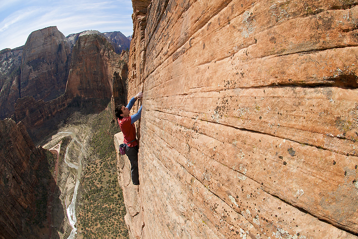 A man rock climbing in Zion National Park, UT. Alex Honnold free soloing Moonlight Buttress IV 5.13a in Zion National Park, UT. He is the first and only person to climb the route in this style.