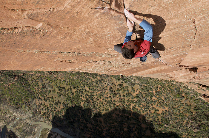 A man rock climbing in Zion National Park, UT. Alex Honnold free soloing Moonlight Buttress IV 5.13a in Zion National Park, UT. He is the first and only person to climb the route in this style.