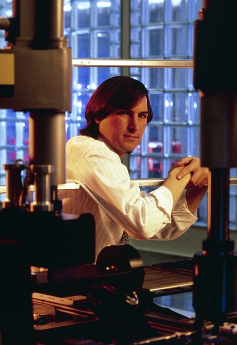 Steve Jobs  Date unknown  Steven Paul Jobs, computer entrepreneur, photographed in the automated factory of NeXT computers, Fremont, California. In 1976, at the age of 21, Jobs co founded Apple Computers with Steve Wozniak. In 1985, after Apple had become a billion dollar company, Jobs was forced out   only to begin plans to launch his next venture, the NeXT computer. Similar in appearance to a conventional personal computer, the NeXT performs like a workstation linked to a mini  or mainframe machine. Like other workstations, it uses the UNIX operating system to run a powerful array of processor chips   an optical memory system. The NeXT computer was launched in October 1988.