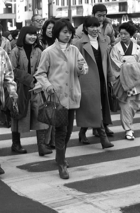A woman carrying a Louis Vuitton bag to work (January 14, 1978): In the 1975s and early 1980s, brand-oriented conservative fashion, or 