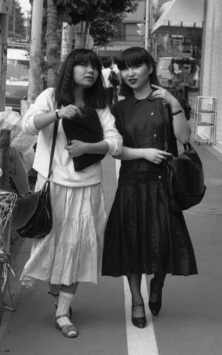 Harajuku Culture  July 11, 1980  Woman walking in Harajuku, July 11, 1980: In the summer of 1980, the trendy monotone  black and white  fashion was popular worldwide. In Harajuku, Tokyo. It s not just about fashion, it s about the freedom to use and wear what you want. Not only fashion, but also products that can be said to be  free to use and wear as you like  are expanding in demand. It seems that the individualization of consumption in the true sense of the word has begun and the market for personal style  self centered living  has finally sprouted.