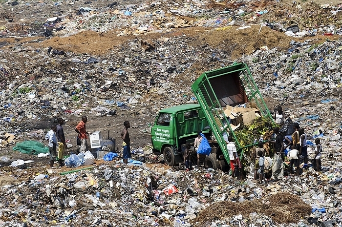 Rubbish dump workers, Sierra Leone Rubbish dump workers. Adults and children collecting recyclable items on a rubbish dump to sell as a way to earn a living.