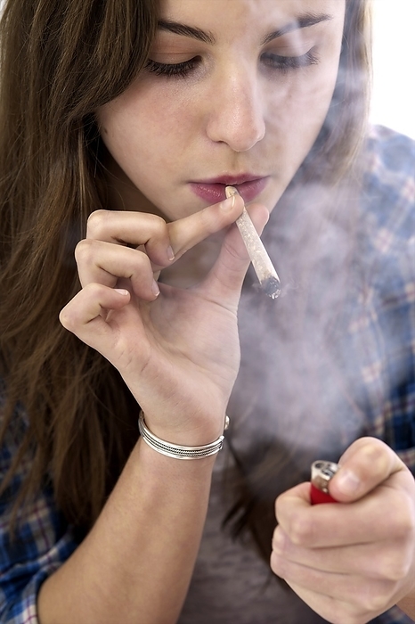 Teenager smoking Teenager smoking. Teenage girl smoking a tobacco cigarette. Tobacco contains cancer causing chemicals and the addictive drug nicotine. Tobacco smoking is a major cause of lung cancer and chronic bronchitis.