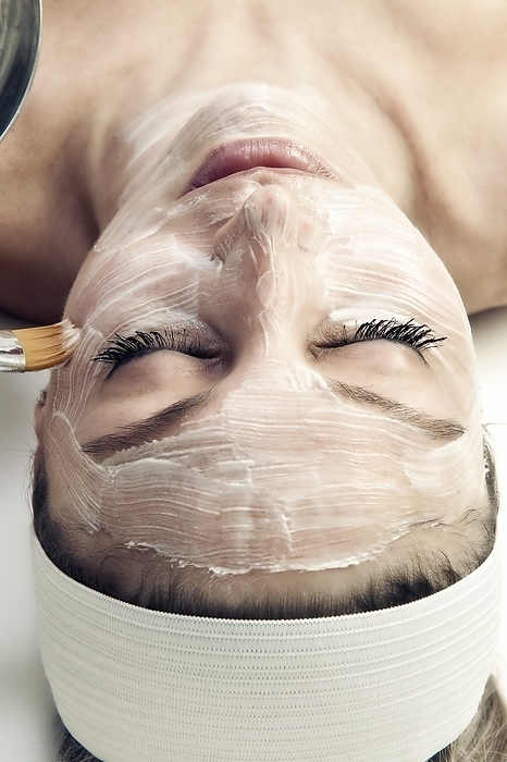 Facial cosmetic treatment Facial cosmetic treatment. Woman receiving a facial cosmetic treatment at a health spa. This is a beauty treatment where the face is covered in a material that is intended to improve the feeling and appearance of the skin. It is intended to moisturize the skin and improve the condition of the pores. The materials applied can include skin oils, and other chemical nutrients.