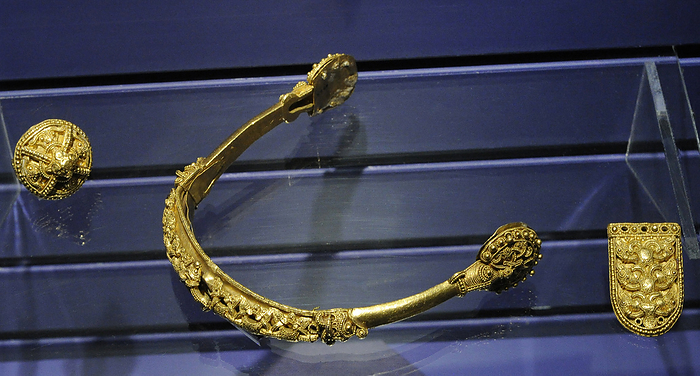 Scandinavia. Gold spur and 2 strap mounts. Barne Kloster, Ostfold, 19th 11th century. Norway.  Scandinavia. Gold spur and 2 strap mounts. Barne Kloster, Ostfold, 19th 11th century. Norway. Historical Museum. Oslo. Norway.