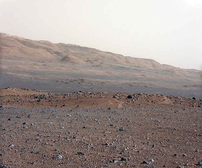 Gale Crater landscape, Mars Gale Crater landscape, as imaged by NASA s Curiosity rover on Mars. This rover, part of the Mars Science Laboratory  MSL  mission, landed here on 6 August 2012. The view looks south south west. In the foreground is an area of gravel, followed by a swale  depression , then the boulder strewn rim  red brown  of a moderately sized impact crater. In the distance are dark dunes and layered rock at the base of Mount Sharp. The horizon is just over 16 kilometres away. Image obtained on 23 August 2012 during calibration of the 34mm Mast Camera. For the same terrain as seen by the telephoto 100mm Mast Camera, see C014 4935.
