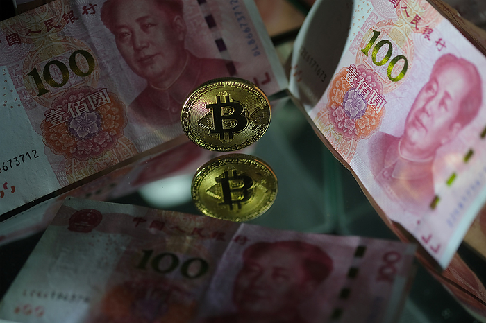 RMB   Bitcoin Image In this photo illustration, one hundred Chinese yuan banknotes with a visual representation of the digital Cryptocurrency, Bitcoin are reflected in mirrors on November 24, 2020 in Katwijk, Netherlands.  Photo by Yuriko Nakao AFLO   