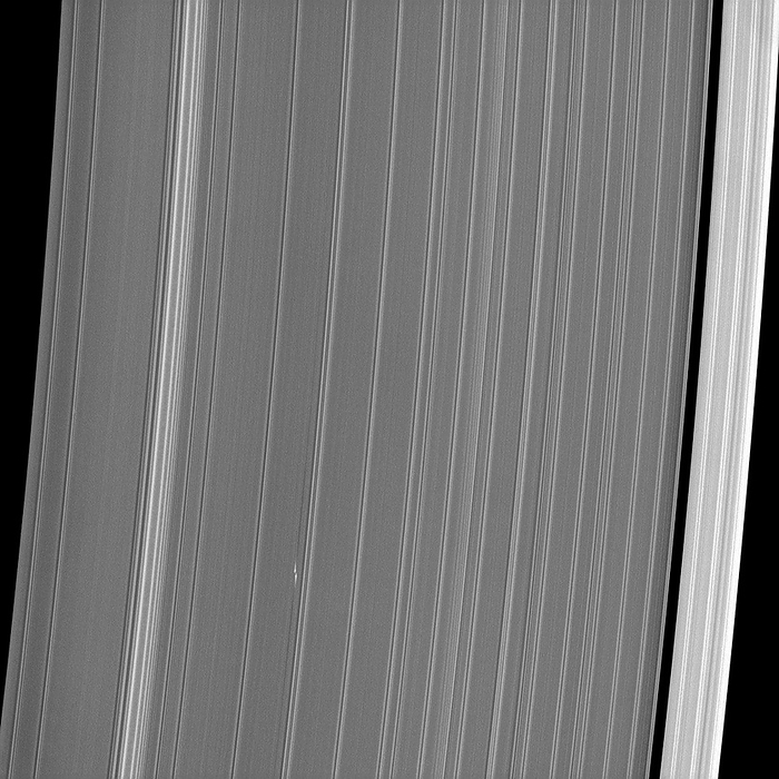 Saturn s rings and moonlet, Cassini image Saturn s rings and moonlet, Cassini image. Close up of the outer part of the A Ring of the gas giant planet Saturn. At right is the Keeler Gap. At left is the start of the Encke Gap. This portion of the rings is around 3190 kilometres across. The small propeller shaped white dashes at lower left show the location of a small moonlet. The propeller  blades  are disturbances  several kilometres long  created by the passage of the moonlet  about 100 metres across . This propeller moonlet has been nicknamed  Bleriot . Image obtained on 11 November 2012, by the narrow angle camera on the orbiting Cassini spacecraft.