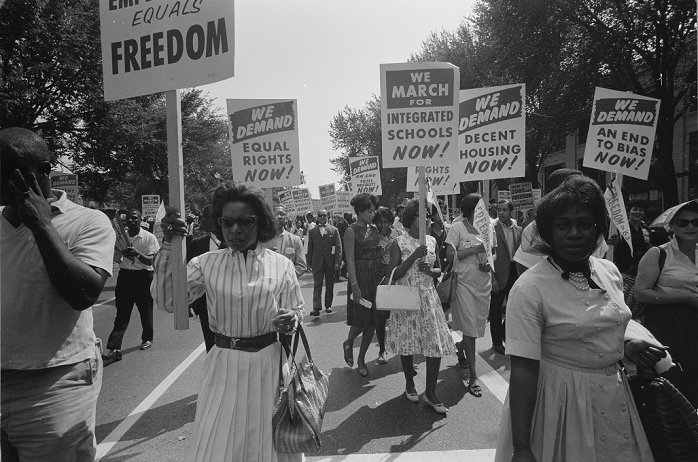 World Events  American Civil Rights Movement March on Washington  August 28, 1963  Civil rights August on Washington, DC, USA. Procession of African Americans carrying placards demanding equal rights, integrated schools, decent housing, and an end to bias. 28 August 1963. Photographer: Warren K Leffler.
