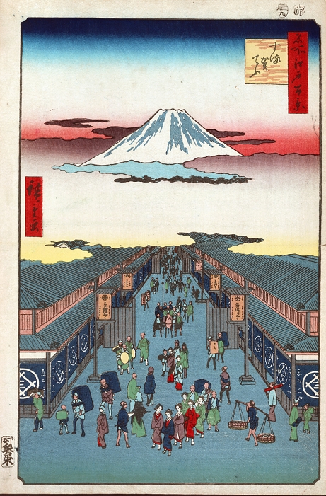 View from Edo, Mt. Suroga Cho: from  One Hundred Famous View of Edo , 1856. Utagawa Hiroshige  1797 1858  Ukiyo e artist. Street scene in Tokyo, Japan, with the summit of Mount Fuji seemingly floating in the clouds. Pedestrians Men Women Porters