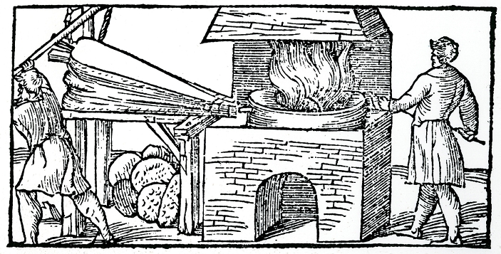 Using bellows to increase draught in furnace for refining copper. Note cupellation cakes of partially refined copper beneath the bellows. From Vannocio Biringuccio De la Pirotechnia, Venice 1540.