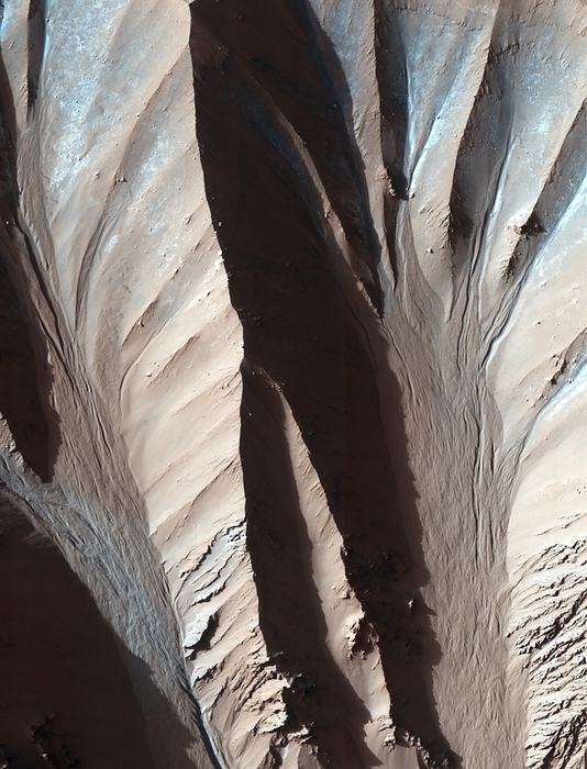 Gully formations on Mars Gully formations on Mars. Mars Reconnaissance Orbiter image of gullies on the side of Gasa Crater in the Southern mid latitudes of Mars. Gullies are narrow channels formed by the downward flow of sediment deposits on steep slopes. The absence of impacts suggests the gullies were formed relatively recently and indicate that water was present on Mars. Image obtained by the High Resolution Imaging Science Experiment  HiRISE  camera on 23rd December 2010.