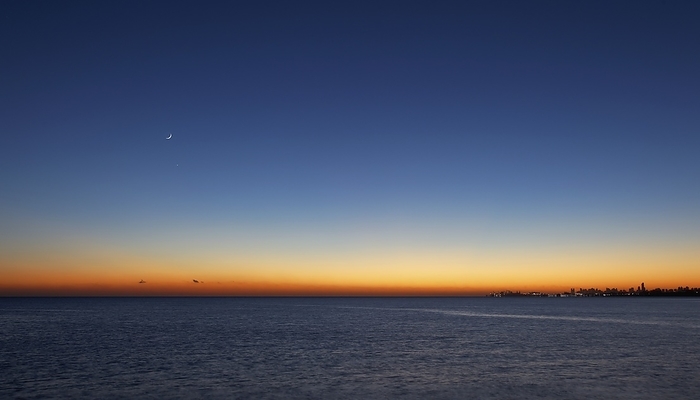 Moon and Venus at sunrise Moon and Venus at sunrise over Buenos Aires. A waning crescent Moon is at centre left, with the planet Venus below it. The skyline of the city of Buenos Aires, Argentina, on the shores of the Rio de la Plata estuary, is at lower right. Photographed in December.