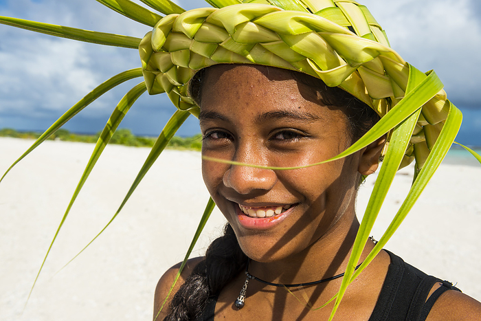 female Portrait of young woman wearing hat made of palm tree leaves