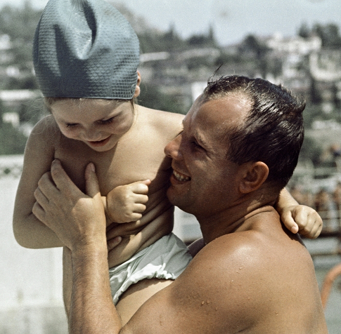 Yuriy Gagarin  September 1964  Gagarin and daughter at the beach. Soviet cosmonaut Yuri Gagarin  1934 1968  with his younger daughter Galina  born 1961  while on holiday at the beach in September 1964. Gagarin, who was a devoted father, had married seven years earlier in 1957, and also had another young daughter  born 1959 . Three years before this photograph was taken, Gagarin had become the first human in space, orbiting the Earth in the Vostok 1 spacecraft on 12 April 1961. Following this historic spaceflight, Gagarin became a hero in the Soviet Union and famous worldwide. Photographed at Gurzuf, on the Black Sea coast, in the Crimea region of the Ukraine.