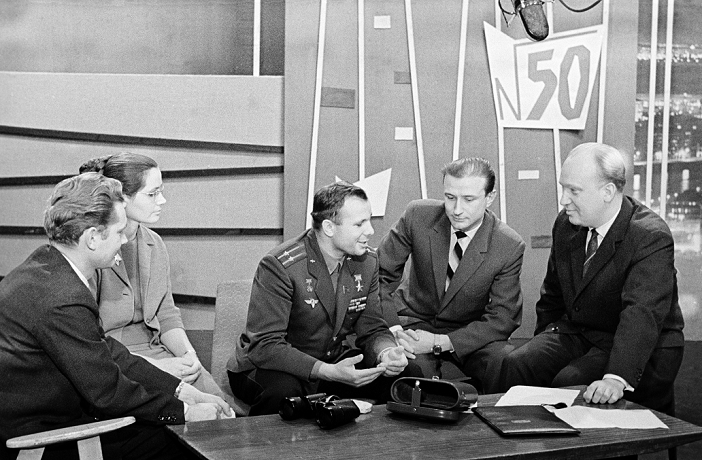 Yuriy Gagarin  July 1963  Yuri Gagarin  1934 1968, centre , Soviet cosmonaut and first man in space, in the studio of the  News Relay  television programme, in Moscow. Gagarin made the first manned space flight on 12 April 1961. He orbited the Earth once in the Vostok 1 spacecraft, a flight that lasted 1 hour and 48 minutes. Gagarin became a hero in the Soviet Union and famous worldwide. He later returned to active service as a test pilot, dying in a crash during a training flight in 1968. His ashes were interred with full military honours in the Kremlin Wall. Photographed in July 1963.