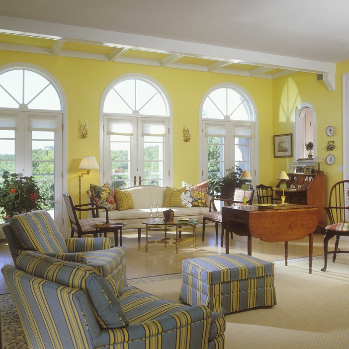 LIVING ROOM - Palladian windows, yellow walls, stripe fabric upholstered chairs, camelback sofa, desk, drop leaf table, ARE RUGS, WOOD FLOORS