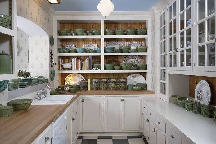 Kitchen: Scullery room connected to kichen by open arch over sinks, glass fronted cabinets, green pottery collection, wood counter tops, black and white slate floor
