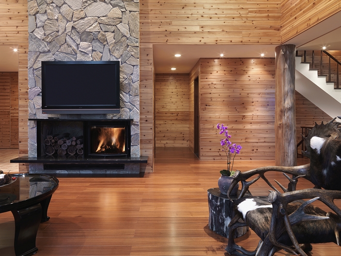 Living room with fur chair and fire place in a cabin home