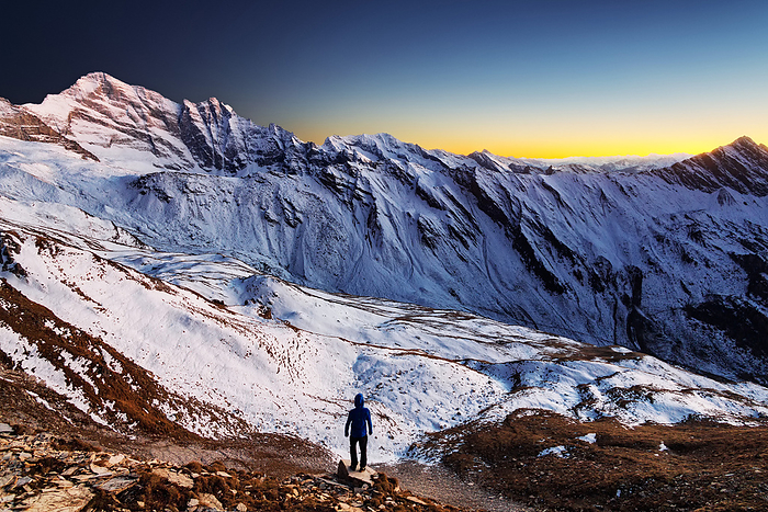 Hiker enjoying the panoramic view at sunset, near Schoeberspitzen in the direction to Steinernes Lamm, over the Tyrolean mountains, Austria, Photo by Furlan, Lukas