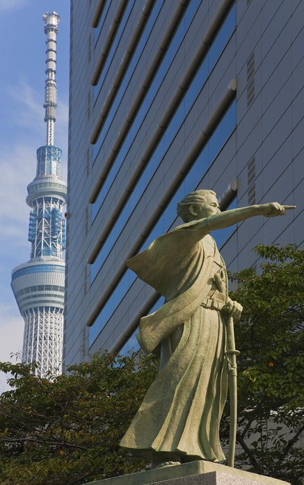 Bronze statue of Kaisyu Katsu and Tokyo Sky Tree Tokyo Sky Tree, the world s tallest free standing broadcast tower at 634 meters, is glimpsed beyond the Sumida City Office and a statue of Katsu Kaishu  an Edo native son and noted 19th century statesman and naval engineer  above the Sumida River, located in the Sumida district of the old shitamachi downtown area in Tokyo, Japan.