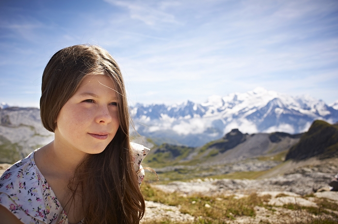 Girl standing in rocky landscape