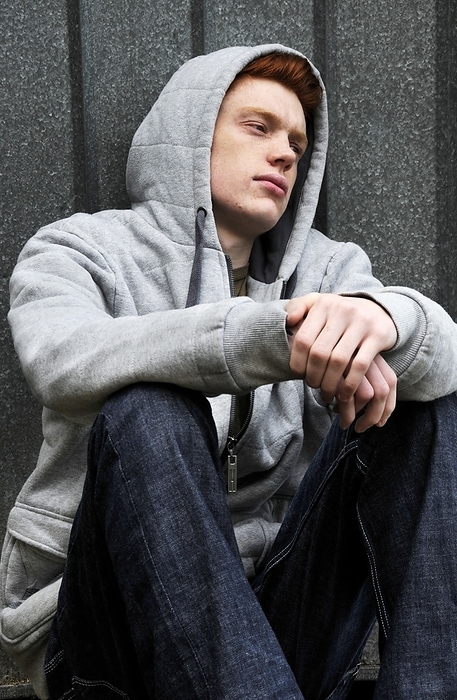 Depressed teenager Depressed teenager. 18 year old depressed teenage boy gazing into the distance.