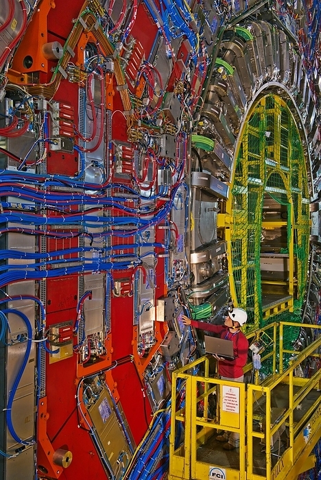 Large Hadron Collider   the CMS Detector A physicist works in the CMS general purpose particle detector at CERN during the 2013 shut down of the Large Hadron Collider. The CMS  Compact Muon Solenoid  detector is constructed in separate vertical layers which can be moved apart so as to allow work on different parts when experiments are not running. The image shows an angled view of one face of one section, with the muon chambers set within the red painted iron return yoke. The central core contains the 7m diameter superconducting wire solenoid and its associated tracker and calorimeter detectors.