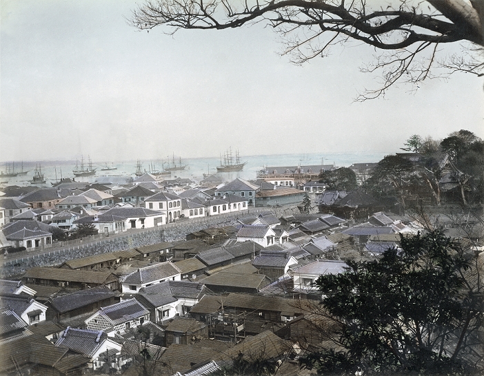 Yokohama  1880s  View on Motomachi, Yokohama Foreign Settlement and Yokohama Harbor from Motomachi Hyakudan at Sengenzaka in Yokohama, Kanagawa Prefecture some time in the 1880s.In the foreground is Motomachi where the original villagers of Yokohama were resettled. Zotokuin Temple is visible on the right.On the other side of the Horikawa canal is the Yamashita Settlement. The oblong building on the coast is the Grand Hotel, which was built in 1887  Meji 20 .