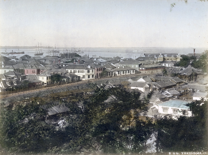 Yokohama  1880s  View on Motomachi, Yokohama Foreign Settlement and Yokohama Harbor from Motomachi Hyakudan at Sengenzaka in Yokohama, Kanagawa Prefecture some time in the 1880s. In the foreground is Motomachi where the original villagers of Yokohama were resettled. Zotokuin Temple is visible on the right. On the other side of the Horikawa Canal  is the Yamashita Settlement. The oblong building on the coast is the Grand Hotel, which was built in 1887  Meji 20 .Also see 80717 0007   View on Yokohama.