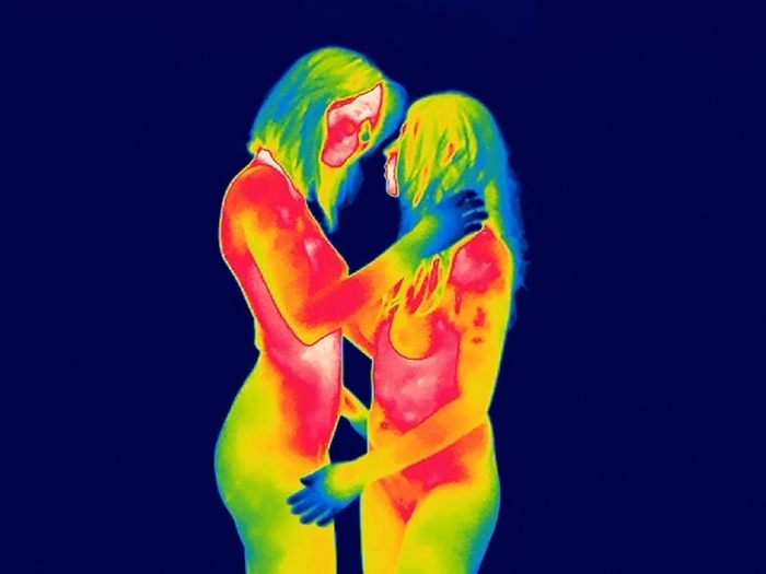 Female couple foreplay, thermogram Female couple foreplay. Thermogram of two nude women in a same sex relationship engaging in foreplay. Thermography records surface temperatures by detecting the long wavelength radiation emitted by an object. Here, the colour coded scale runs from white  warmest  through pink, red, orange, yellow, green and blue to black  coldest .