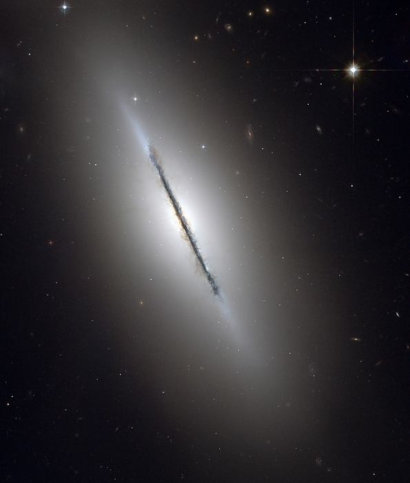 Galaxy NGC 5866, Hubble image Galaxy NGC 5866. Hubble Space Telescope  HST  image of the disk galaxy NGC 5866 tilted nearly edge on to the line of sight, and revealing a crisp dust lane dividing the galaxy in two halves. NGC 5866 lies around 44 million light years from Earth, in the constellation Draco. Imaged by the Advanced Camera for Surveys on the Hubble Space Telescope, in November 2005.