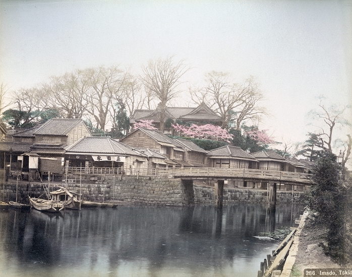 Asakusa  unknown date  Imado bashi Bridge spanning the Sanya River in the Asakusa district, Tokyo. In the back is Matsuchiyama, a small hill on the west side of the Sumida River. On top, Honryuin can be seen. Locally known as Matsuchiyama Shoten, it is a sub temple of Senso ji and dedicated to Bishamonten, one of the Seven Gods of Good Luck. Japanese author Kafu Nagai mentioned this place in his novel Sumida River.