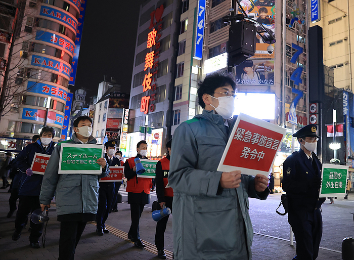 Local government officers ask people to stay home January 15, 2021, Tokyo, Japan   Local government officers and police officers hold placards and ask people to stay home at Shinjuku entertainment district amid outbreak of the new coronavirus in Tokyo on Friday, January 15, 2021. Japanese government declared a state of emergency on Tokyo and 10 other prefectures this week and requested nightclubs and restaurants to close 8 pm.         Photo by Yoshio Tsunoda AFLO 