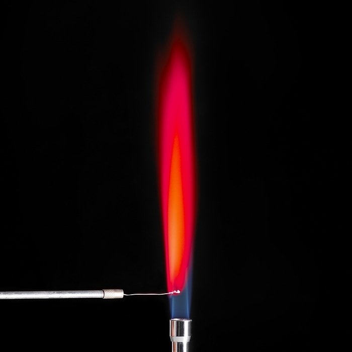 Lithium flame test Lithium flame test. Positive result of a flame test for lithium  Li , producing a deep red colour. This is due to the excitation of electrons in the lithium by the heat of the flame. As these electrons lose their energy, they emit photons of deep red light. The colour of the flame is different for different elements and can be used to identify unknown substances. The metal compound being tested here is lithium chloride.
