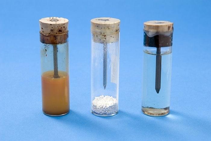 Corrosion of iron demonstration Corrosion of iron demonstration. Iron nails in sealed test tubes containing  from left to right : water, anhydrous calcium chloride and boiled water, showing different levels of corrosion  rust, orange . Rust is an iron oxide formed by the reaction of iron and oxygen in the presence of water. Normal water  left  contains a high proportion of oxygen so this nail rusts the most. Anhydrous calcium chloride acts as a desiccant, removing moisture from the air and preventing the middle nail from rusting. Boiling water  right  removes some of the oxygen meaning that this nail does rust but does so much slower than the left tube.