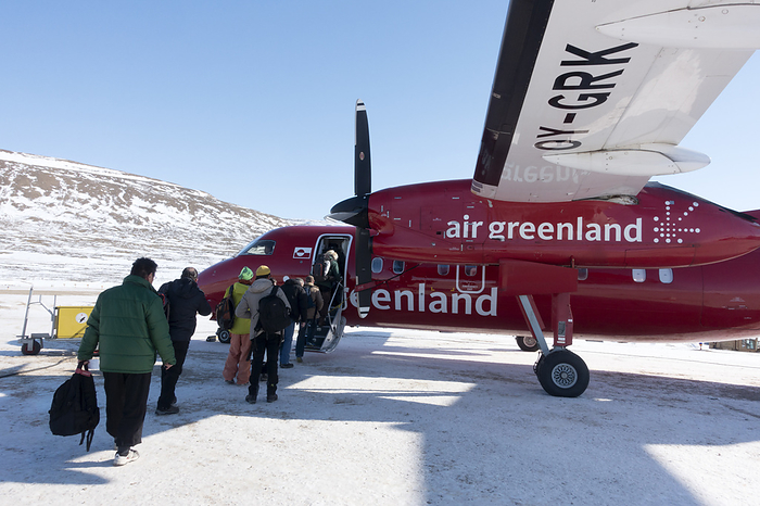 Air Greenland aeroplane Air Greenland aeroplane. Passengers boarding an Air Greenland Dash 8 aeroplane at Qaanaaq airport, Thule, Greenland. This aircraft is a twin engined, medium range, turboprop airliner. Photographed in April 2015.