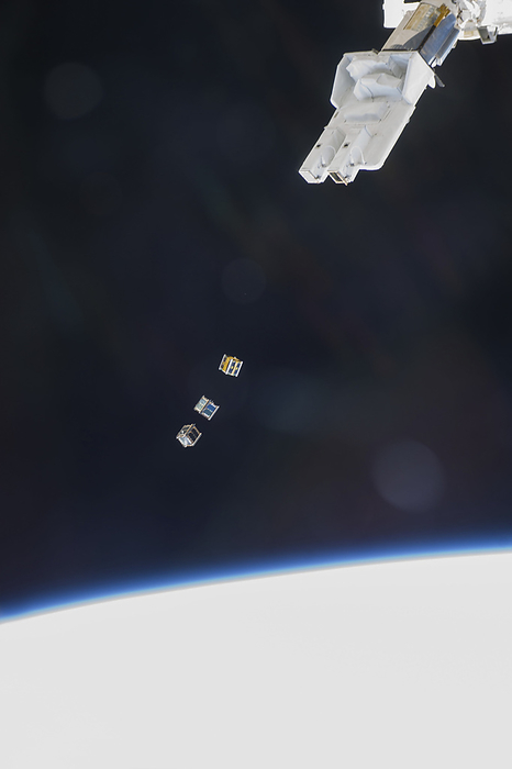 ISS deploying satellites ISS deploying satellites. Astronaut photograph of three nanosatellites, known as Cubesats, being deployed from a Small Satellite Orbital Deployer  SSOD  attached to the robotic arm of the Kibo laboratory on the International Space Station  ISS . These Cubesats were delivered to the ISS on 9th August 2013 onboard Japan s fourth H II Transfer Vehicle, Kounotori 4. Photographed by an Expedition 38 crew member from inside Kibo, on 19th November 2013.