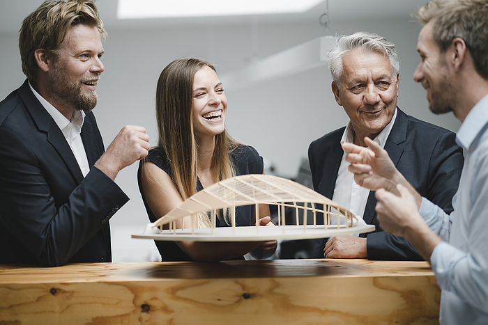 Business Successful business people looking at architectural model in office