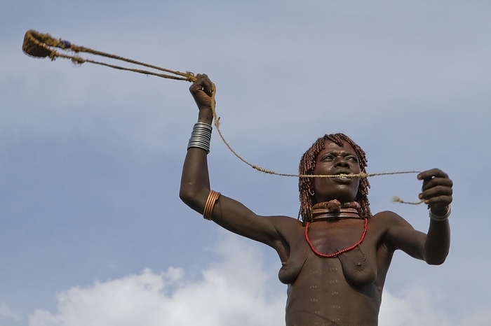 Hamer Tribe woman, Ethiopia Africa, Ethiopia, Omo River Valley Hamer Tribe woman hunts with a slingshot